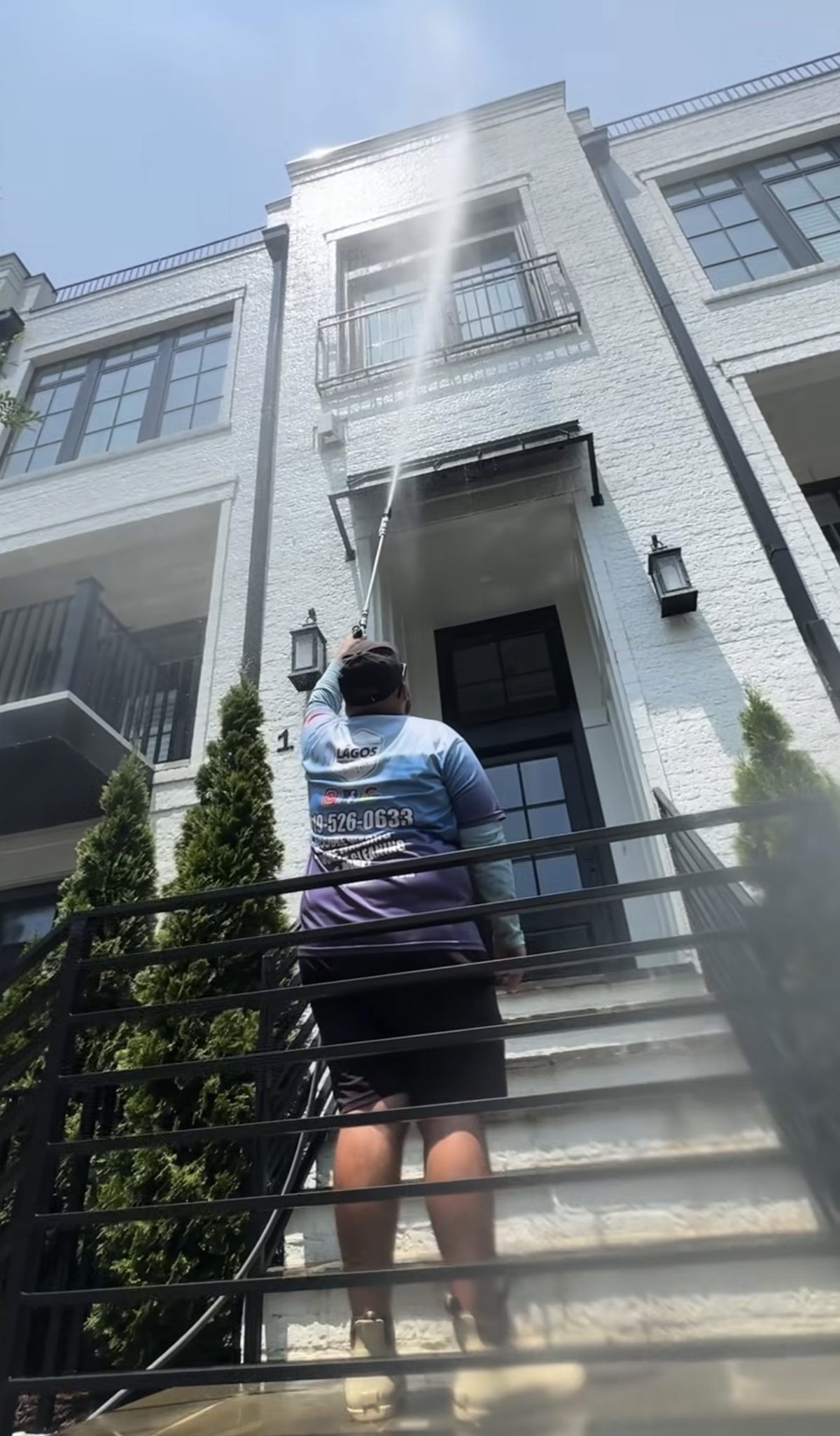 Lagos Pressure Washing technician washing a Raleigh home exterior
